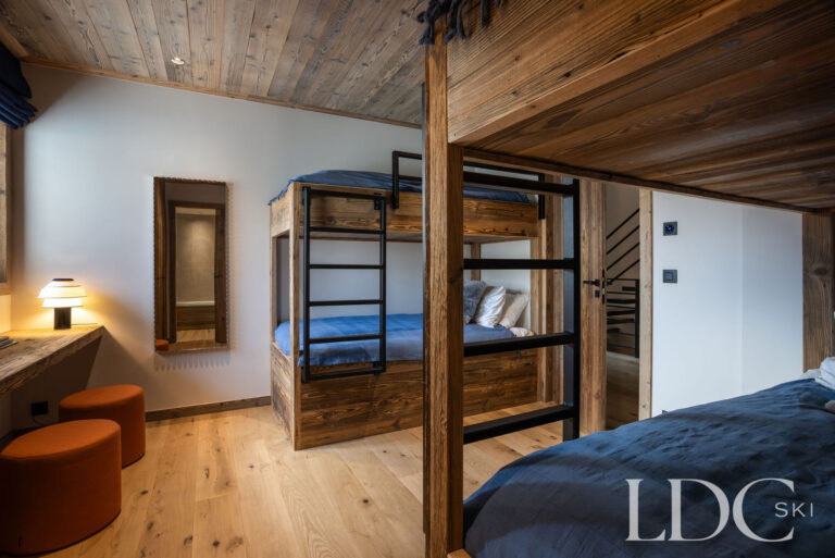 Chalet Aurea family bedroom with double bed and bunk beds