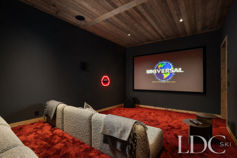 Chalet Aurea private cinema room with large screen and tiered seating