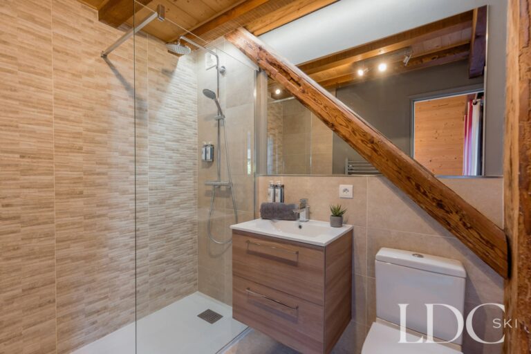 Contemporary walk-in shower room with exposed timber at Chalet Aux Joux