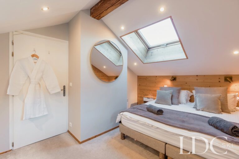 Double bedroom with skylight and timber detailing at Chalet Aux Joux
