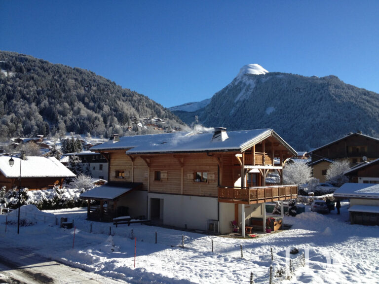 Chalet Aux Joux in its snowy mountain setting in Morzine