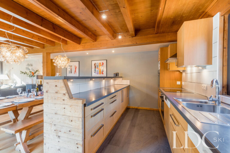Open-plan kitchen leading through to the dining room at Chalet Aux Joux