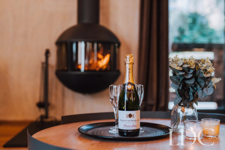 Suspended wood-burning fireplace in the lounge at Chalet Aux Joux