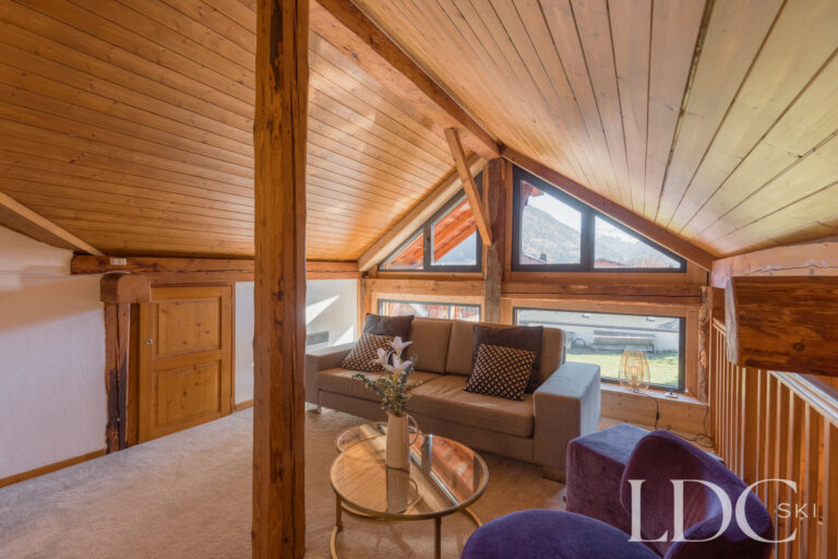 Mezzanine seating area beneath the vaulted timber ceiling at Chalet Aux Joux