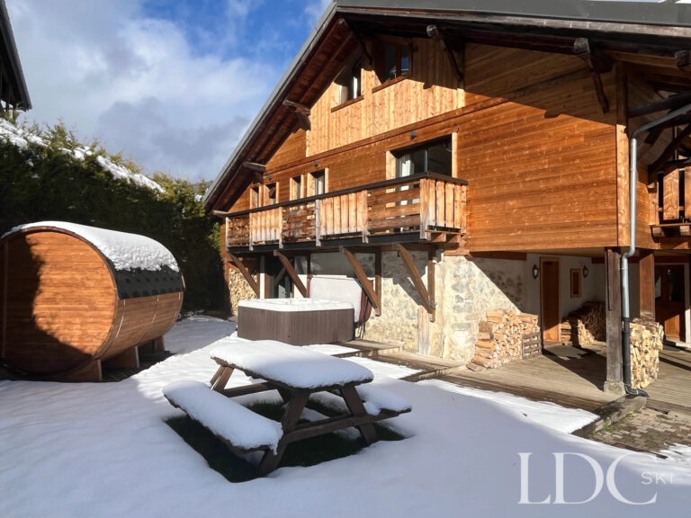 Timber exterior and snowy garden at Chalet Aux Joux in Morzine