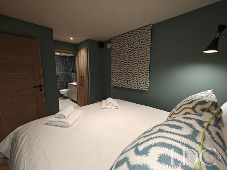 Double bedroom with balcony access and mountain views at Chalet Chardon in St Martin de Belleville