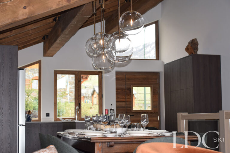Modern kitchen with breakfast bar and wooden cabinetry at Chalet Chardon in St Martin de Belleville