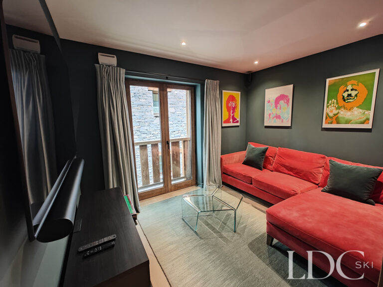 Comfortable TV and cinema room with large screen and sofas at Chalet Chardon in St Martin de Belleville