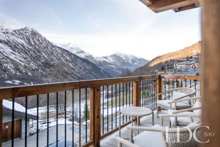 Chalet de Beauvoir balcony with seating and views across the Belleville Valley