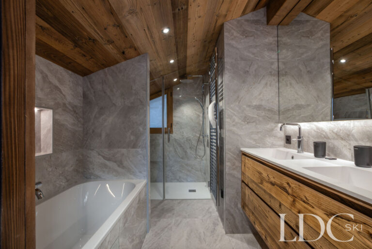 Spacious bathroom with bath, walk-in shower and double vanity at Chalet de Beauvoir