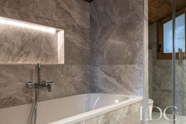 Contemporary bathroom with bath, illuminated niche and walk-in shower at Chalet de Beauvoir