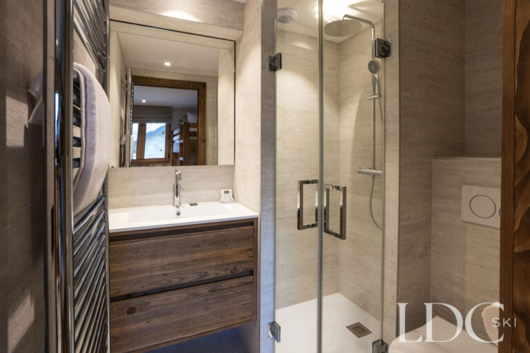 Contemporary shower room with walk-in shower and wooden vanity at Chalet de Beauvoir
