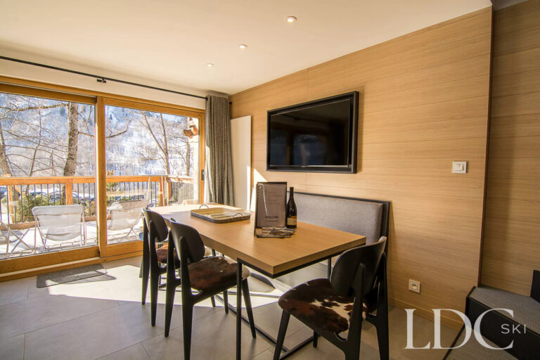 Bernardie dining area with doors opening towards the balcony