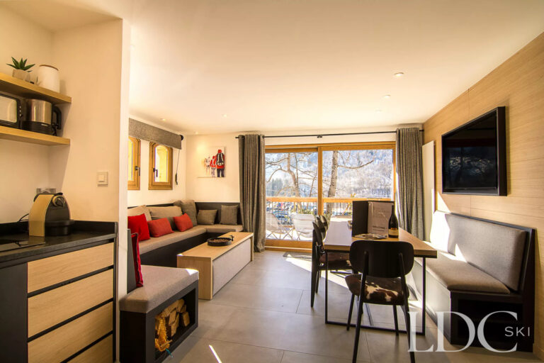 Bernardie open-plan living and dining area with balcony doors