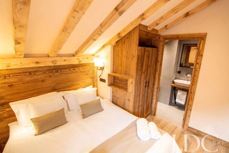 Double bedroom with view of ensuite bathroom at Chalet Camarine St Martin de Belleville