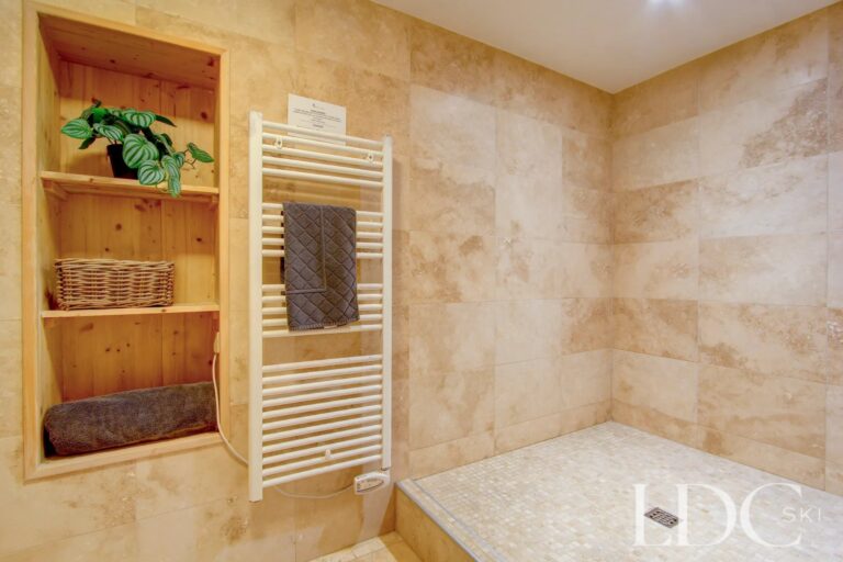 Chalet Jouet bathroom with stone tiling and heated towel rail