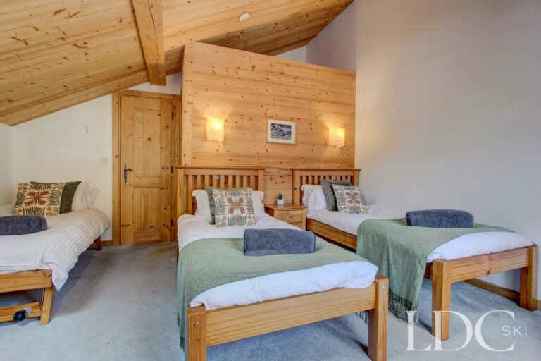 Chalet Jouet triple bedroom with vaulted timber ceiling
