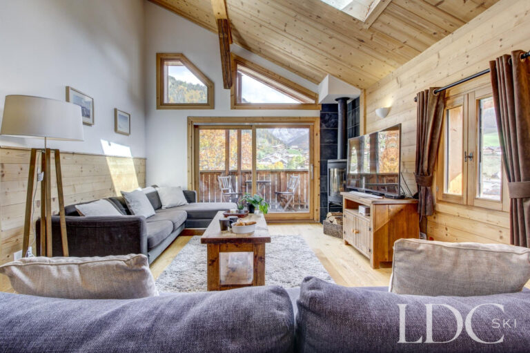 Chalet Jouet spacious lounge with vaulted timber ceiling and large windows