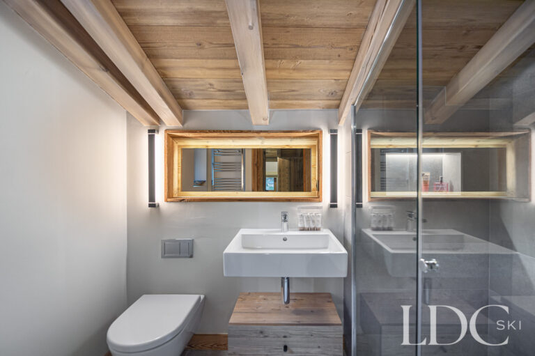 Shower room at Chalet La Fermette with walk-in shower, basin and timber features