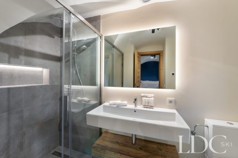 En-suite shower room at Chalet La Fermette with walk-in shower and illuminated mirror