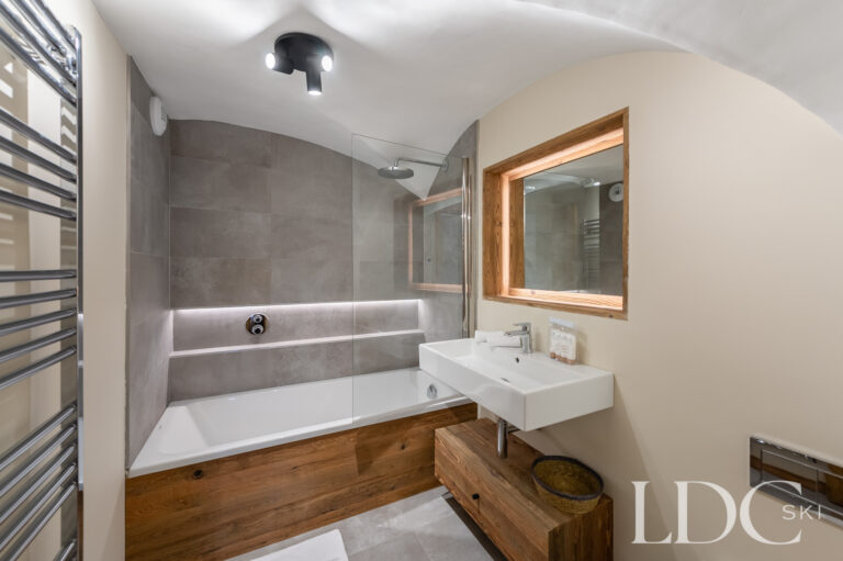 Bathroom at Chalet La Fermette with bath, shower and double basins