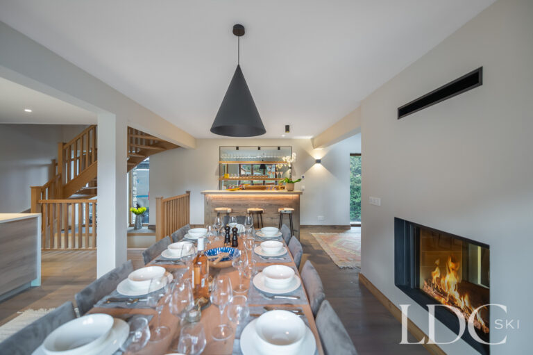 Dining area at Chalet La Fermette with large table and contemporary fireplace