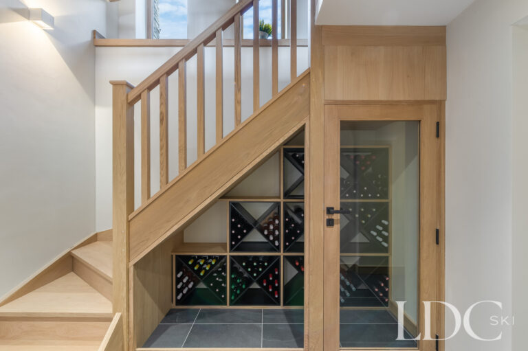 Timber staircase at Chalet La Fermette with integrated wine storage