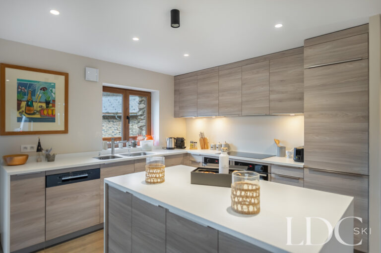 Contemporary kitchen at Chalet La Fermette with central island and mountain views