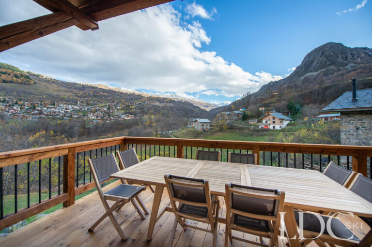 Chalet La Fermette terrace with outdoor dining and views across the Belleville Valley