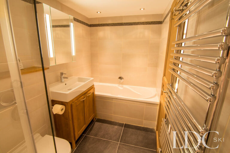 Bathroom at Chalet Le Pic Blanc with bath, shower screen and basin