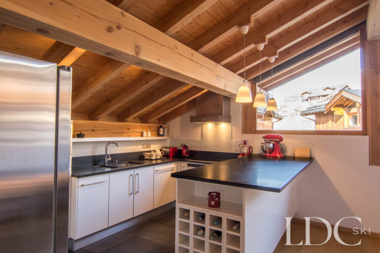 Chalet Le Pic Blanc kitchen with breakfast bar and windows overlooking the mountains