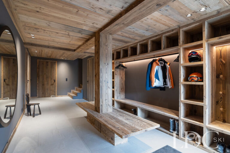 Ski and boot room at Chalet Lenafaju with extensive storage, hanging space and bench seating