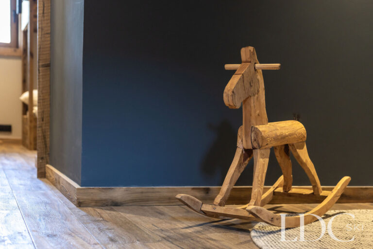 Decorative wooden reindeer and contemporary alpine interior detail at Chalet Lenafaju