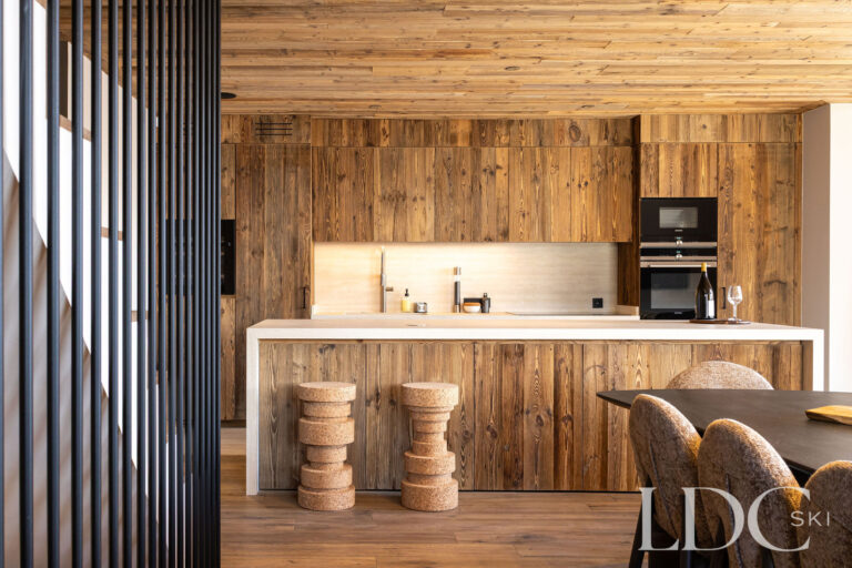 Timber kitchen at Chalet Lenafaju with breakfast bar and contemporary alpine interiors