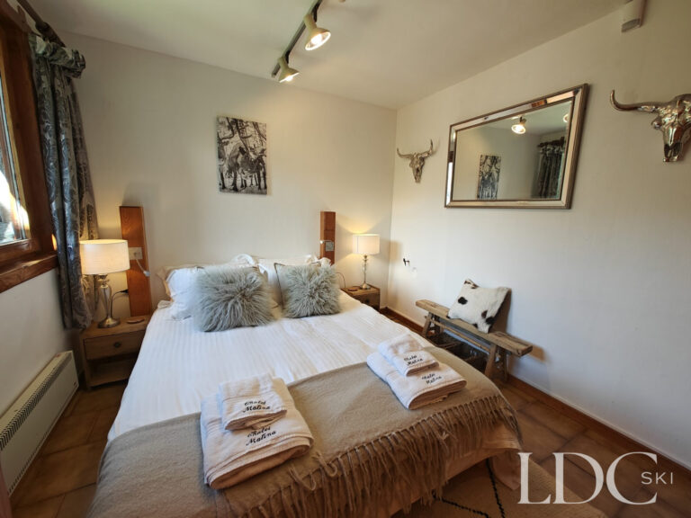 Cosy double bedroom at Chalet Malina with wooden furnishings and alpine-inspired décor