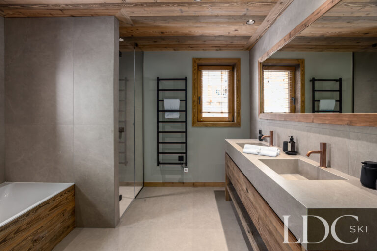 Bathroom at Chalet Montana with double basins, walk-in shower and contemporary alpine finishes