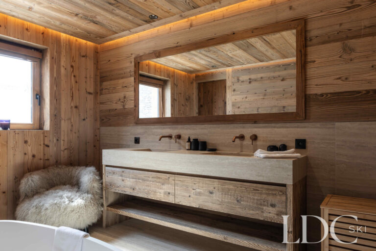 Bathroom at Chalet Montana with long wooden vanity, double basins and timber panelling