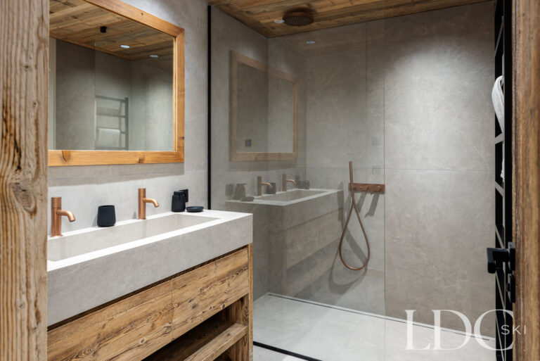 Contemporary bathroom at Chalet Montana with double basins and glass walk-in shower