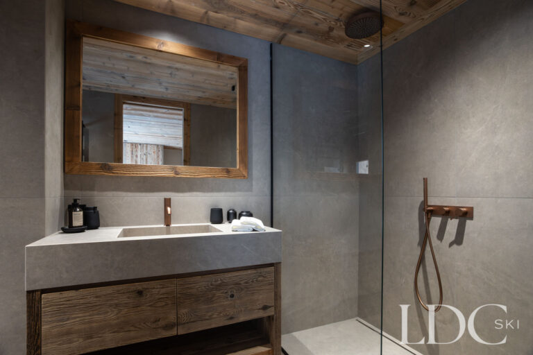 Shower room at Chalet Montana with wooden vanity, walk-in shower and contemporary finishes