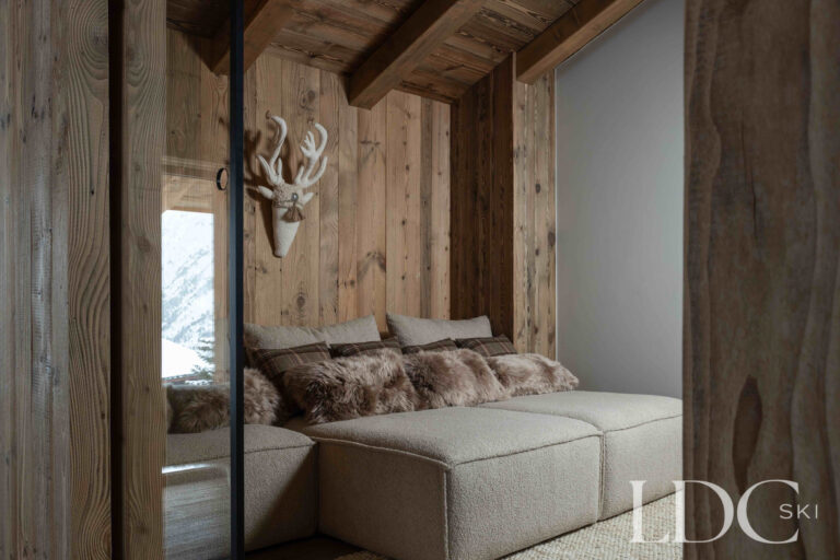 Cinema room at Chalet Montana with comfortable seating and timber-panelled walls