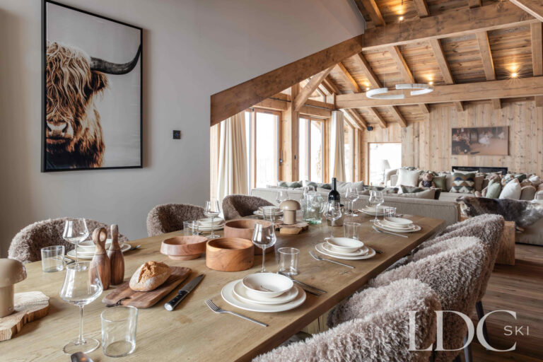 Dining table at Chalet Montana with open-plan lounge, exposed beams and alpine interiors