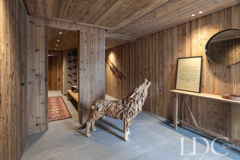 Entrance hall at Chalet Montana with natural timber walls and contemporary alpine furnishings