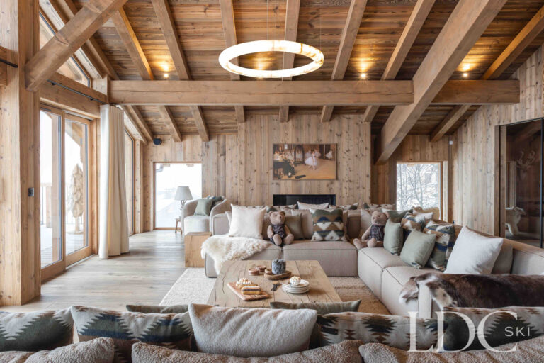 Lounge at Chalet Montana with floor-to-ceiling windows, exposed beams and mountain views