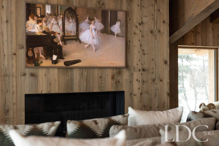Lounge at Chalet Montana with fireplace, television and timber-clad walls