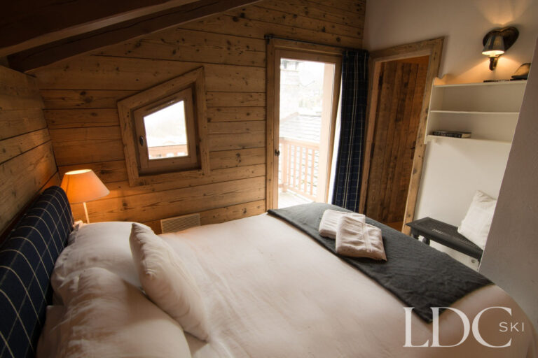 Double bedroom at Chalet Riondaz with balcony access and mountain views