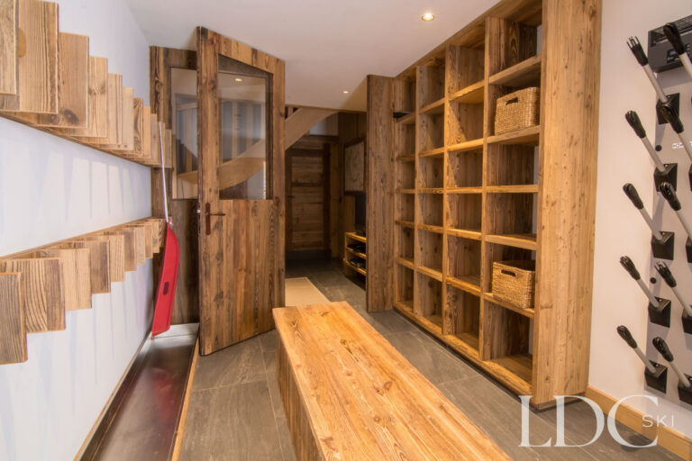 Spacious ski and boot room at Chalet Riondaz with equipment storage and bench seating