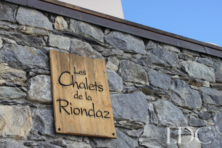 Les Chalets de la Riondaz sign on the stone exterior in St Martin de Belleville
