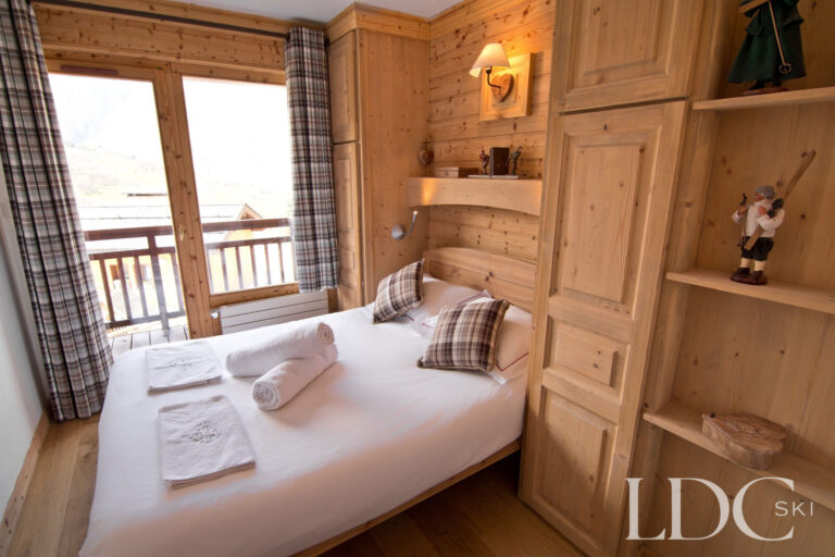 Double bedroom at Chalet Saint Peres with balcony doors overlooking the mountains
