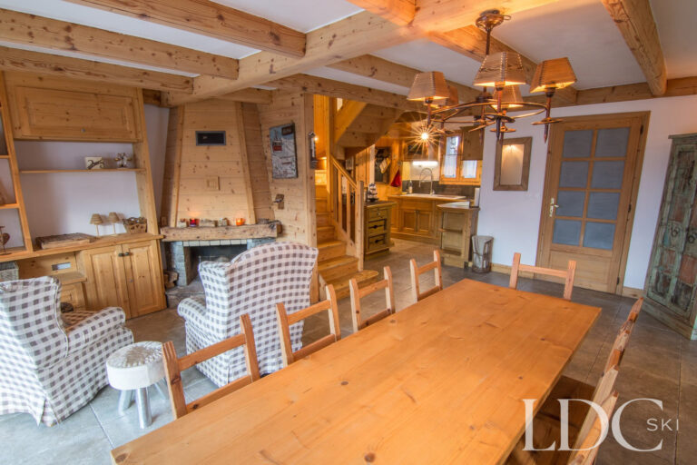 Open-plan dining and living area at Chalet Saint Peres with traditional timber interiors