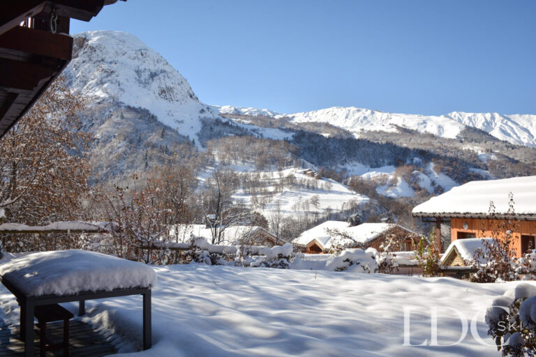 Snow-covered mountains and village rooftops viewed from Chalet Saint Peres in St Martin de Belleville